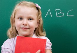 Child in front of blackboard